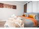 Serene bedroom with a comfortable bed, decorative pillows, an orange throw, and accent wall at 3490 Primrose Pl, Decatur, GA 30032