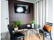 Cozy dining area features a round table, wall-mounted TV, and neutral-colored curtains at 3490 Primrose Pl, Decatur, GA 30032