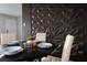 Dining area with a sleek black table and chairs with an eye-catching accent wall at 3490 Primrose Pl, Decatur, GA 30032