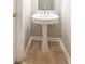 A pedestal sink with a tiled floor in a neutral colored bathroom at 493 Townsend Bnd, Stockbridge, GA 30281