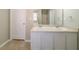 Bathroom featuring a double sink vanity with white cabinets and a large mirror at 493 Townsend Bnd, Stockbridge, GA 30281