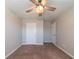 Cozy bedroom featuring soft carpet and ceiling fan, complemented by two closets at 493 Townsend Bnd, Stockbridge, GA 30281