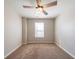 Neutral bedroom featuring soft carpet, ceiling fan, and window letting in natural light at 493 Townsend Bnd, Stockbridge, GA 30281