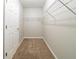 Carpeted walk-in closet with adjustable wire shelving and a door at 493 Townsend Bnd, Stockbridge, GA 30281