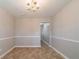 Dining room featuring wainscoting, tiled floors and a chandelier at 493 Townsend Bnd, Stockbridge, GA 30281