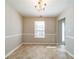 Bright dining room featuring wainscoting, tiled floors and a chandelier at 493 Townsend Bnd, Stockbridge, GA 30281