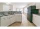 Bright kitchen featuring white cabinets, modern backsplash, and a spacious layout at 493 Townsend Bnd, Stockbridge, GA 30281