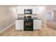 Well-lit kitchen featuring black appliances and ample cabinet storage at 493 Townsend Bnd, Stockbridge, GA 30281