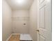 A simple laundry room with tile flooring and a shelf on the wall at 493 Townsend Bnd, Stockbridge, GA 30281