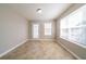 Sunlit living room featuring tiled floors and a door to the backyard at 493 Townsend Bnd, Stockbridge, GA 30281
