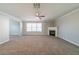 Cozy living room featuring a fireplace, large windows, and plush carpeting at 493 Townsend Bnd, Stockbridge, GA 30281