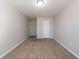 Cozy room featuring neutral walls, carpet flooring, and a window at 493 Townsend Bnd, Stockbridge, GA 30281