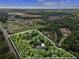 Aerial view of 4.95 acres highlighting the property's large lot size and secluded location surrounded by mature trees at 5323 Presley Pl, Douglasville, GA 30135