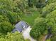 Aerial view of a home with a long driveway, a manicured lawn, and a framed garden at 5323 Presley Pl, Douglasville, GA 30135