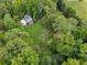 An aerial view of a secluded home with lush greenery and trees surrounding the property, creating a private oasis at 5323 Presley Pl, Douglasville, GA 30135