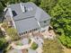 Aerial view of a home showcasing its patio and landscaped yard surrounded by lush trees at 5323 Presley Pl, Douglasville, GA 30135