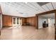 Finished basement with hardwood floors, paneled walls, and double french doors at 5323 Presley Pl, Douglasville, GA 30135