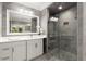 Elegant bathroom features a glass shower, white vanity, and a large framed mirror at 5323 Presley Pl, Douglasville, GA 30135