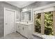 Bathroom featuring a white vanity, a framed mirror and a window providing natural light at 5323 Presley Pl, Douglasville, GA 30135