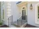 Close up of front entrance of the home featuring stone steps, black door, and an outdoor light fixture at 5323 Presley Pl, Douglasville, GA 30135