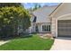 Beautiful view of home with a large tree in front of the home, manicured lawn and two-car garage at 5323 Presley Pl, Douglasville, GA 30135