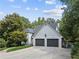 Two-story house with an attached two-car garage, gray roof and stucco at 5323 Presley Pl, Douglasville, GA 30135