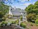 Beautifully landscaped backyard and house exterior with a large patio and mature trees at 5323 Presley Pl, Douglasville, GA 30135