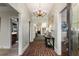 Grand foyer with brick flooring, elegant chandelier, and views into other rooms at 5323 Presley Pl, Douglasville, GA 30135