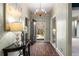Inviting foyer features brick floors, elegant lighting, and stylish wallpaper creating a warm welcome to the home at 5323 Presley Pl, Douglasville, GA 30135