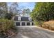 Detached garage with three bays and driveway in a wooded setting at 5323 Presley Pl, Douglasville, GA 30135