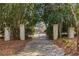 Wrought iron gate with stone pillars at the entrance to the tree-lined driveway at 5323 Presley Pl, Douglasville, GA 30135