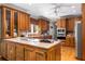 Well-equipped kitchen with stainless steel appliances, wood cabinetry, and a tiled center island at 5323 Presley Pl, Douglasville, GA 30135