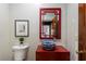 Bright powder room features blue vanity sink and red decorative mirror at 5323 Presley Pl, Douglasville, GA 30135