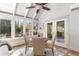 Cozy sunroom with stone floors, a dining area, and large windows with natural light at 5323 Presley Pl, Douglasville, GA 30135