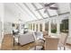 Stylish sunroom featuring stone floors, high ceilings, windows for lots of light and flexible layout for entertaining at 5323 Presley Pl, Douglasville, GA 30135