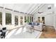 Bright sunroom boasting lots of natural light, stone floors, beamed ceilings, and a view of the beautiful outdoors at 5323 Presley Pl, Douglasville, GA 30135