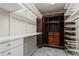 Spacious walk-in closet with custom shelving and antique cabinet for optimal storage at 5323 Presley Pl, Douglasville, GA 30135