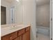 Well-lit bathroom featuring a vanity with ample storage and a separate area for the shower and tub at 5480 Beaver Ridge Dr, Cumming, GA 30040