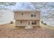 View of the back exterior of the house, back yard and a small patio area at 6797 Mahonia Pl, Lithonia, GA 30038