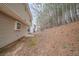 View of the side of the house and the treed backyard at 6797 Mahonia Pl, Lithonia, GA 30038