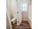 Cozy bathroom showcasing tile floors, toilet, and a window for natural light at 6797 Mahonia Pl, Lithonia, GA 30038