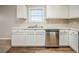 Clean kitchen featuring stainless steel dishwasher and white cabinetry at 6797 Mahonia Pl, Lithonia, GA 30038