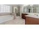 A bathroom features a soaking tub, glass-enclosed shower, and double sink vanity at 1011 Buckhorn Bnd, Locust Grove, GA 30248