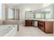 A bathroom features a soaking tub, glass-enclosed shower, and double sink vanity at 1011 Buckhorn Bnd, Locust Grove, GA 30248