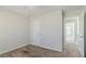 Carpeted bedroom with door to hallway, ceiling fan, and white walls at 1011 Buckhorn Bnd, Locust Grove, GA 30248