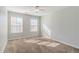 A bedroom features plush carpeting, neutral walls, and bright, natural lighting at 1011 Buckhorn Bnd, Locust Grove, GA 30248