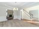 Well-lit dining room with a chandelier and views of the living room and staircase at 1011 Buckhorn Bnd, Locust Grove, GA 30248