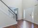 Inviting foyer featuring hardwood floors, a staircase with white railings, and a bright, welcoming atmosphere at 1011 Buckhorn Bnd, Locust Grove, GA 30248