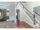 Spacious foyer boasting hardwood floors, neutral walls, and a staircase leading to the upper level at 1011 Buckhorn Bnd, Locust Grove, GA 30248