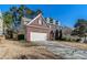 View of a charming brick and siding home with a two-car garage and well-maintained landscaping at 1011 Buckhorn Bnd, Locust Grove, GA 30248
